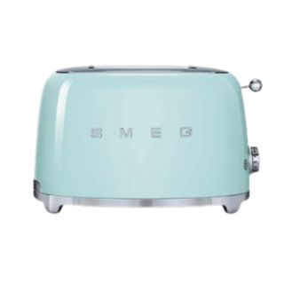 A light blue toaster with 'Smeg' in silver letters on the front, rounded edges, and silver feet and handles