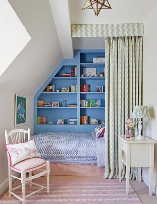 Small children's room with blue fitted storage and single bed
