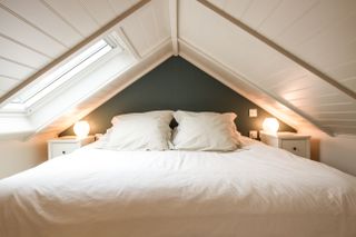 white bedroom with double bed in an attic space of a garage conversion by Aquila Property Group