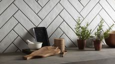 white subway tiles in kitchen with fresh herbs and chopping board