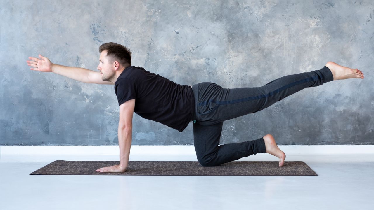 A man performing the bird dog exercise