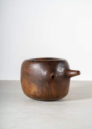 Brown handcrafted vessel with two handles.