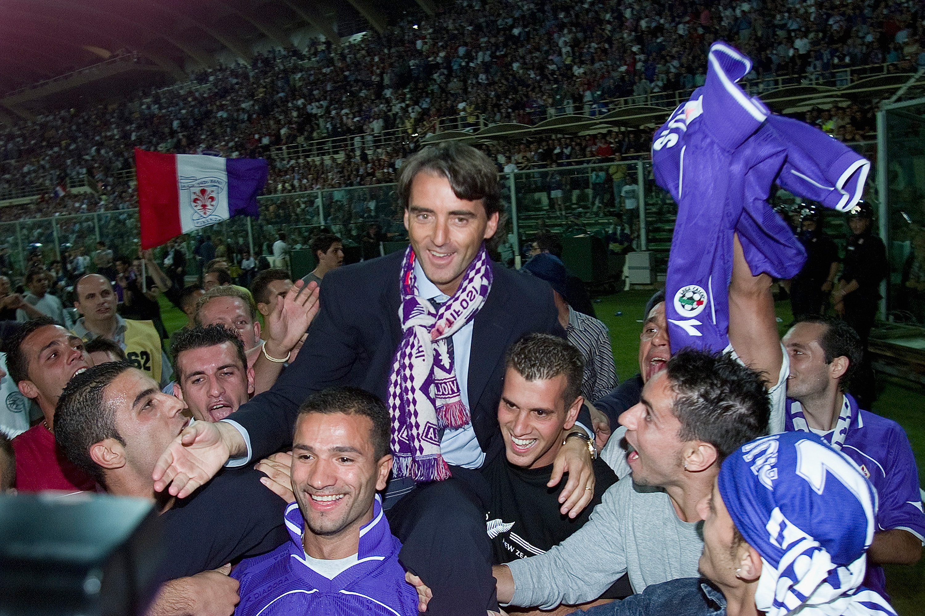 Fiorentina coach Roberto Mancini celebrates the club's Coppa Italia final win over Parma in June 2001.