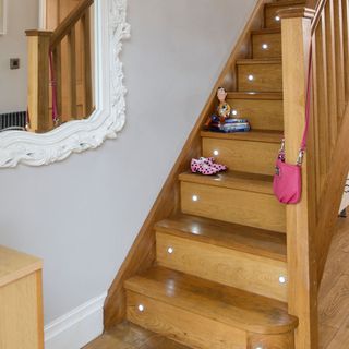 Wooden hallway stairs with spotlights