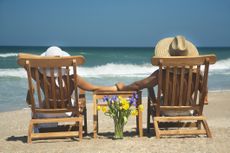 vacation couple relaxing in teak chairs enjoying perfect day in Florida