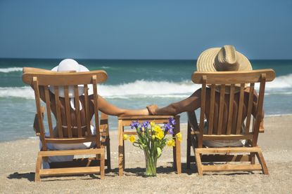 vacation couple relaxing in teak chairs enjoying perfect day in Florida