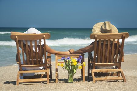 vacation couple relaxing in teak chairs enjoying perfect day in Florida