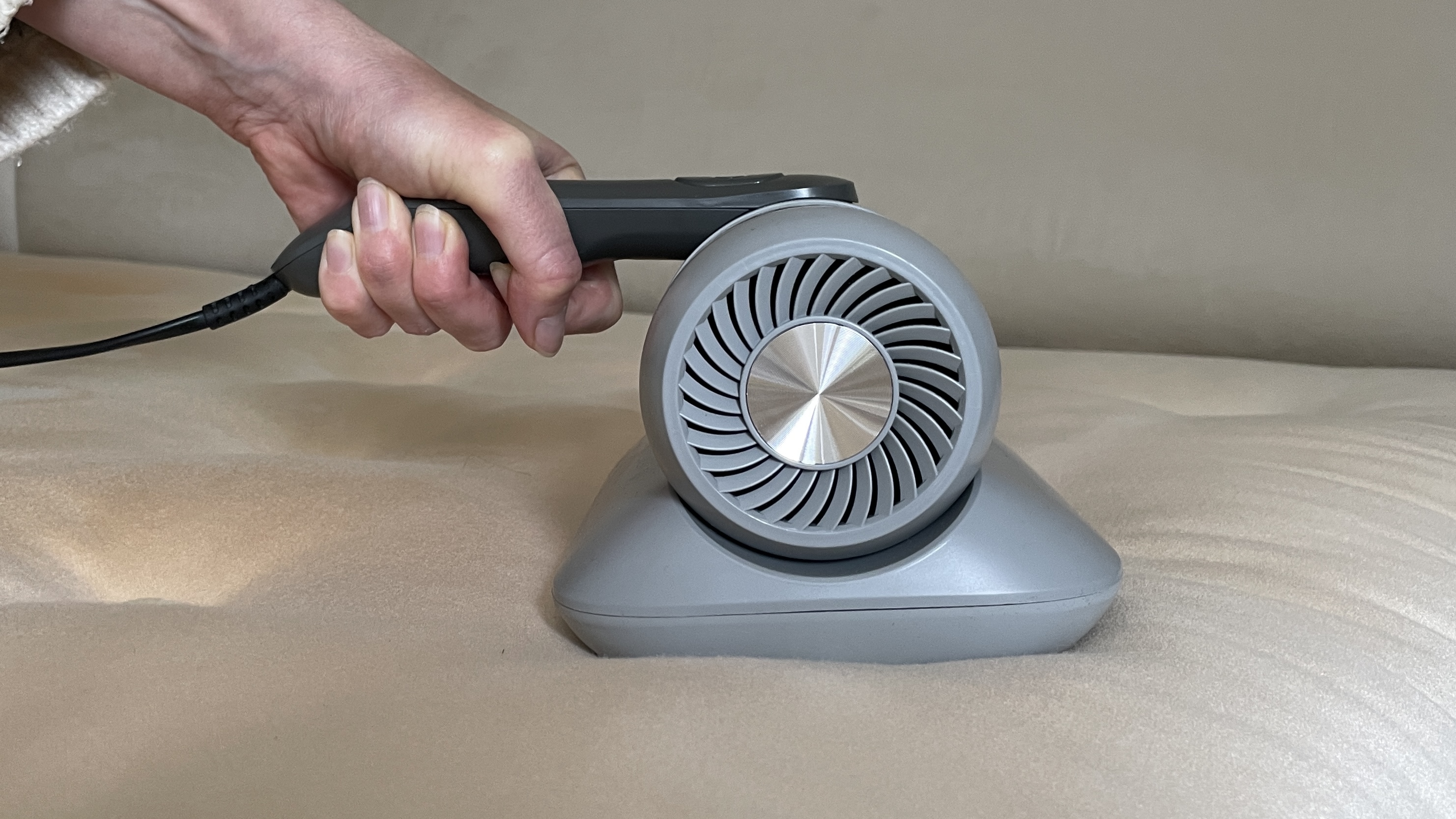 Aldi's Ambiano Mattress Vacuum being used on a mattress and sofa