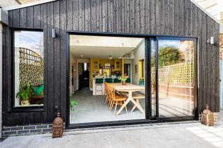 black clad kitchen and diner extension with large sliding doors