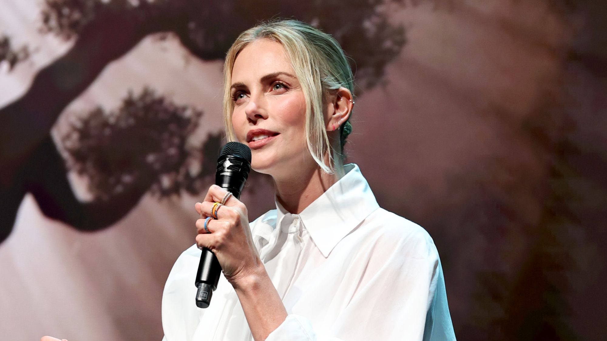 Charlize Theron speaks on stage at Netflix's Upfront 2025 in New York City
