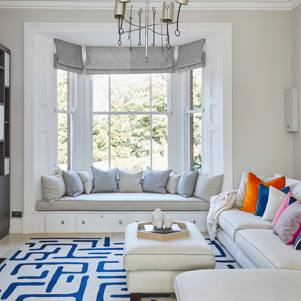 living room with white walls and sofaset with cushions