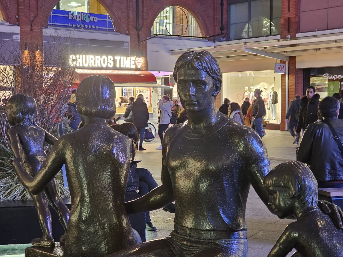 statues of a man and children
