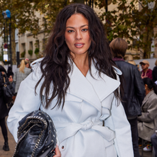 Ashley Graham with wavy hair and light makeup posing for the camera