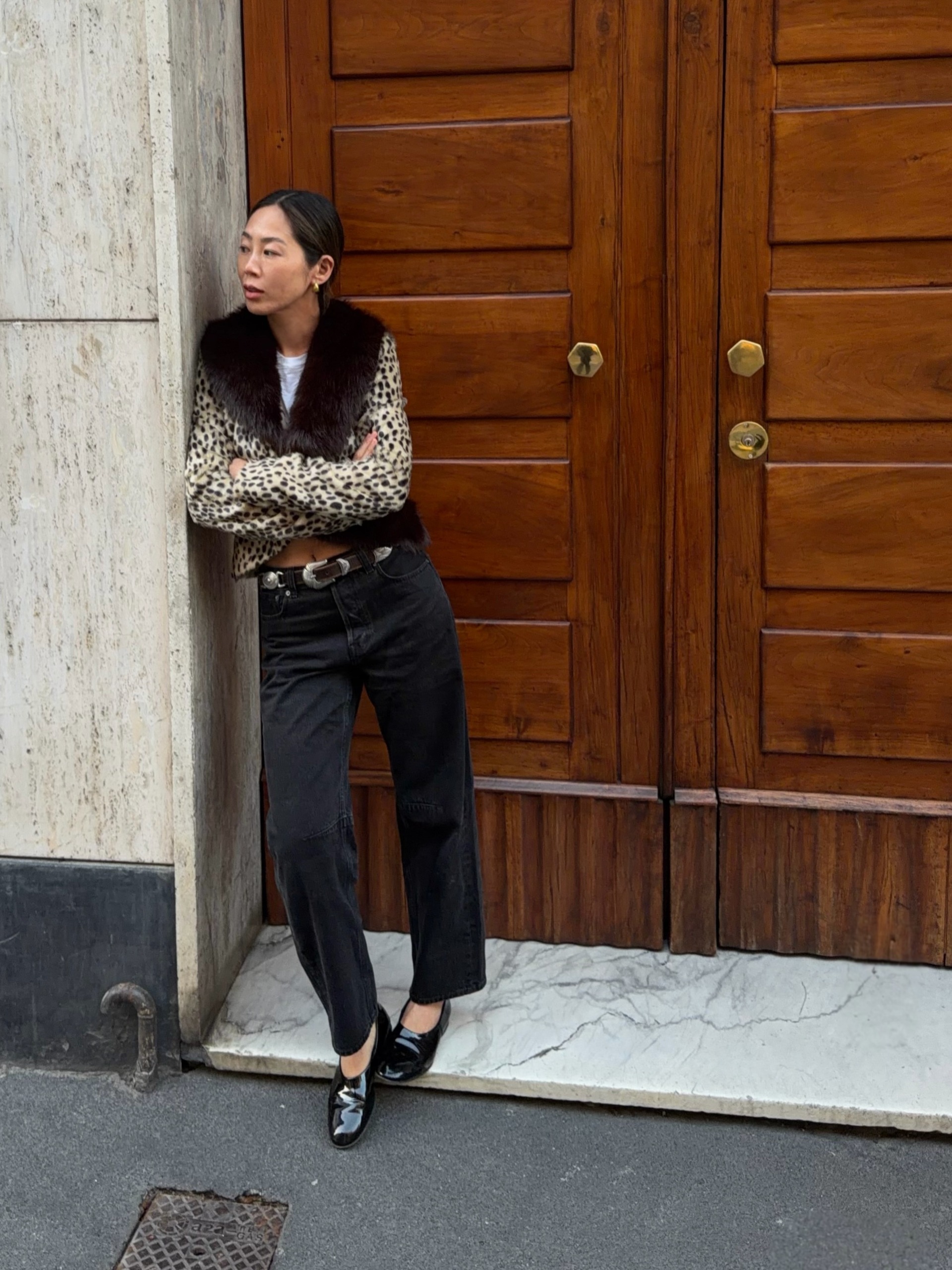 fashion influencer wearing a leopard-print jacket and black jeans