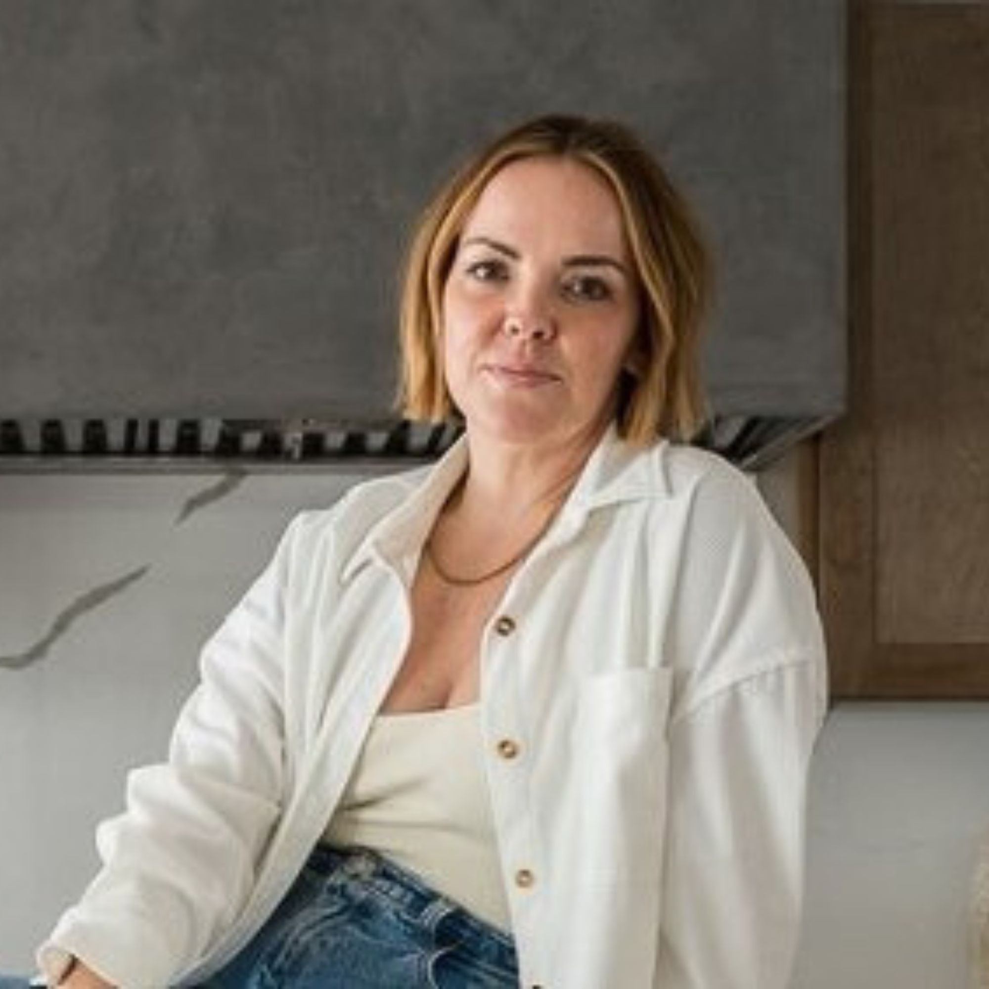 A picture of Heather Knight-Willcock, a woman wearing a white shirt and blue jeans