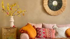 living room with pink sofa, easter tree and rattan mirror 