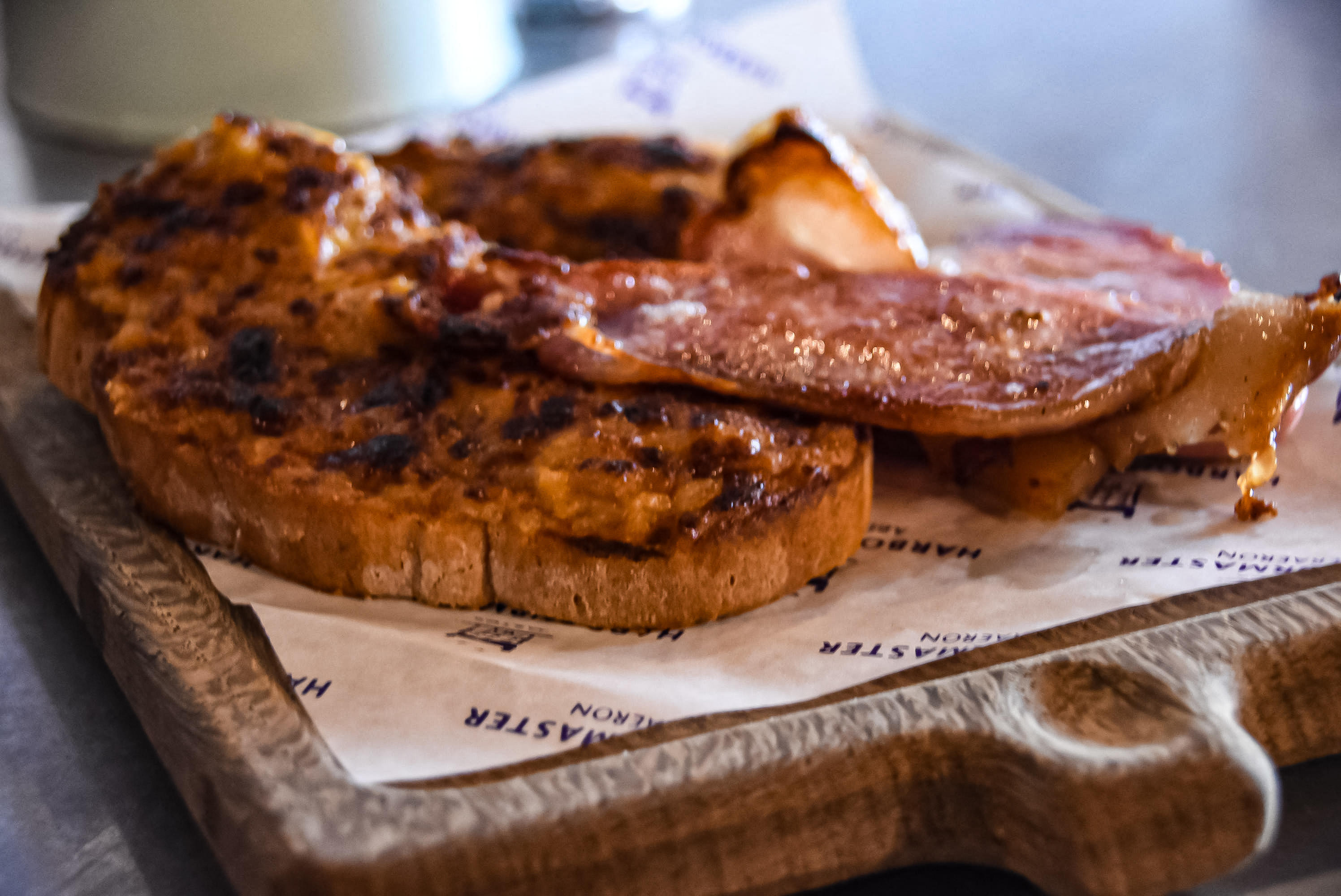 two pieces of welsh rarebit, served on a chopping board