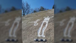 The newly found petroglyphs from Sweden include depictions of humans. Here we see one tall human with their arms throw up in the air.