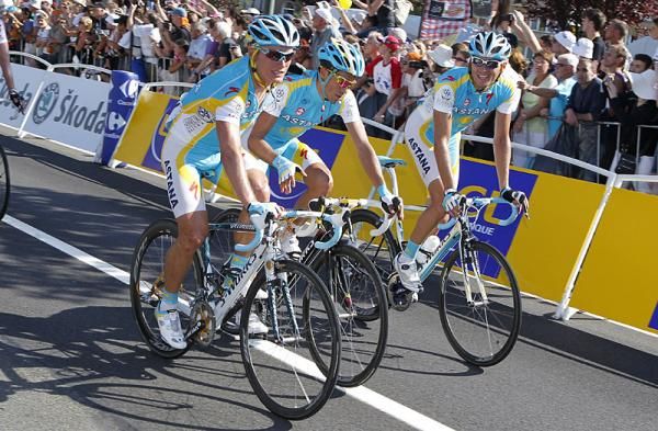 Alexandre Vinokourov helps Astana teammate Alberto Contador cross the finish line in Brussels.