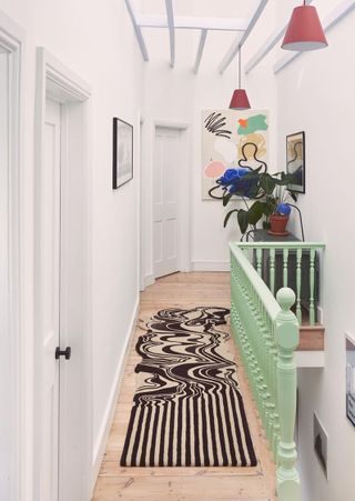 a modern hallway with an artistic rug
