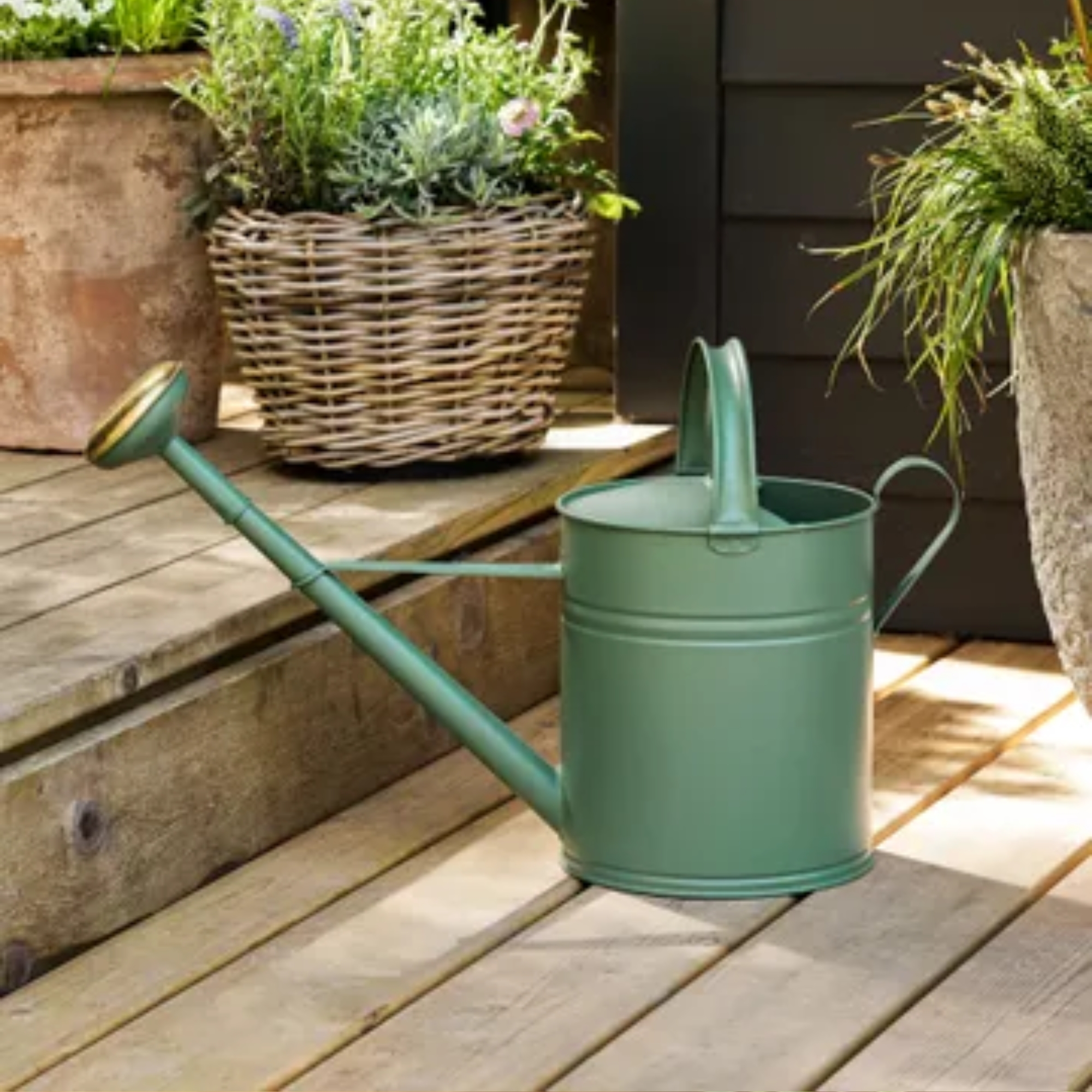 Garden Trading Watering Can on decking with rattan in the background