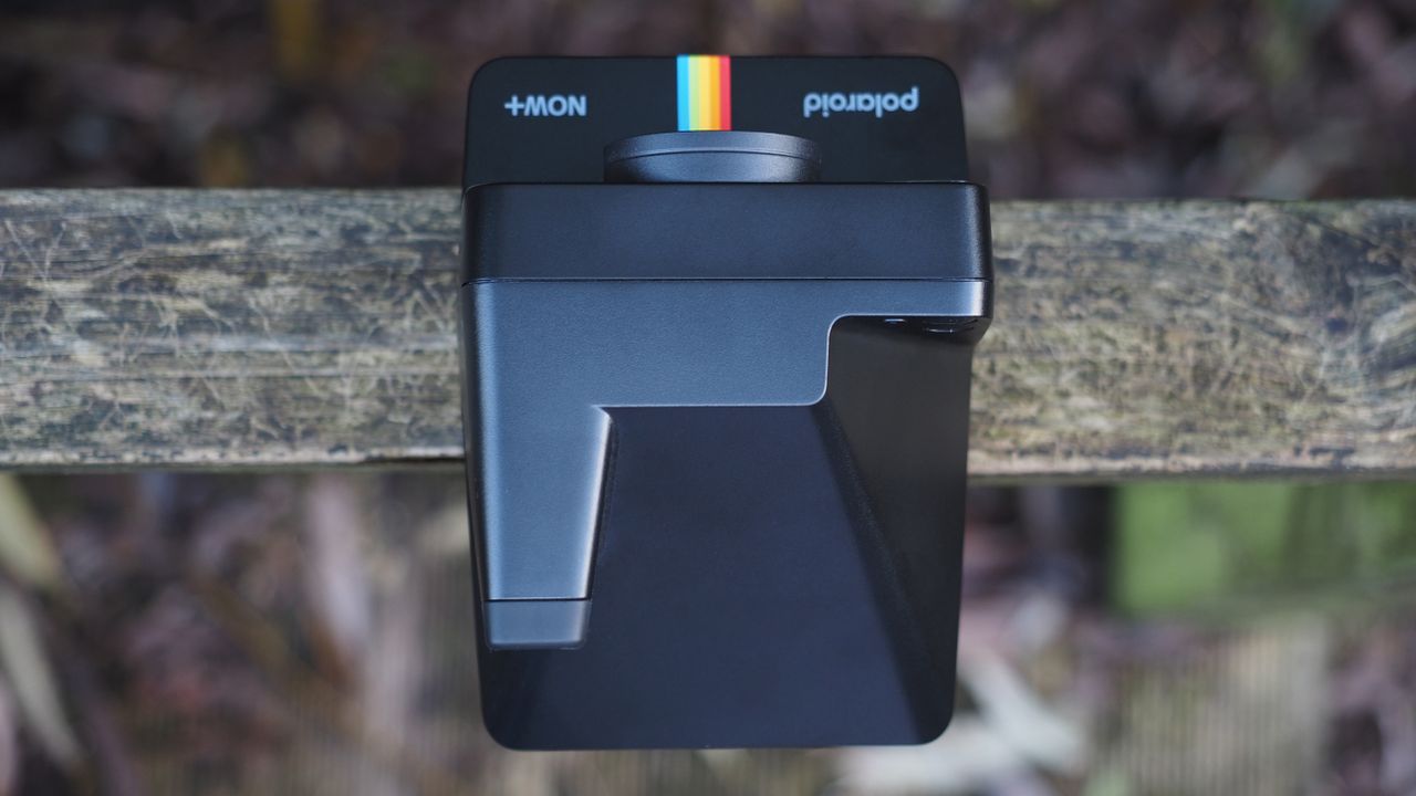 Polaroid Now+ Generation 2 on a wooden surface, in a woodland setting