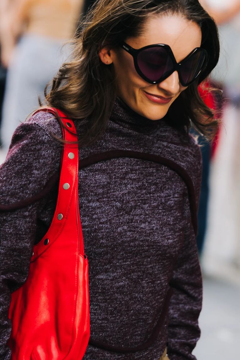 a fashion week guest wearing bug eye sunglasses