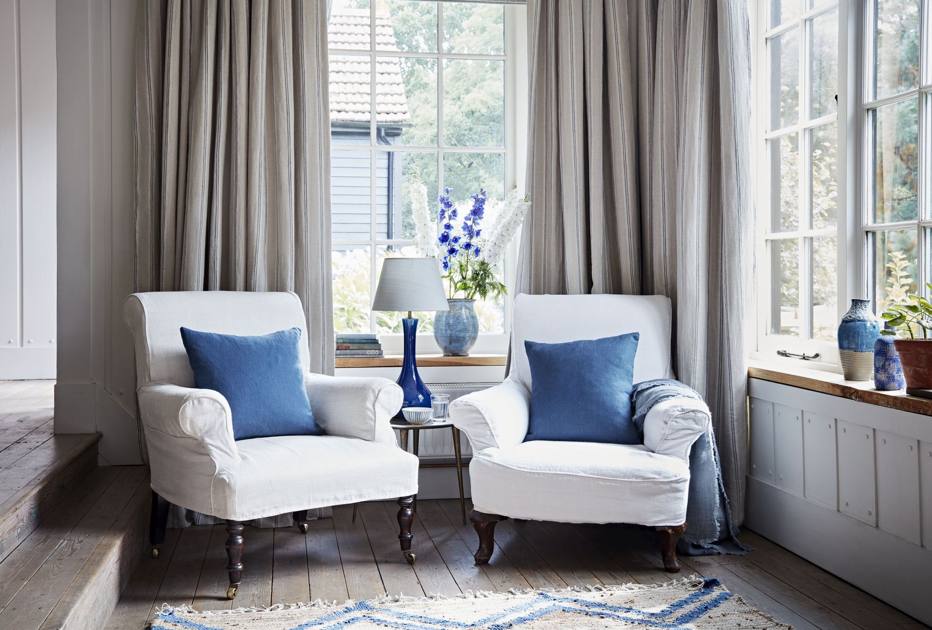 Window treatment for corner window with armchairs in front