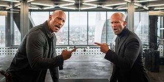 Hobbs & Shaw pointing at each other, calling each other out in a conference room