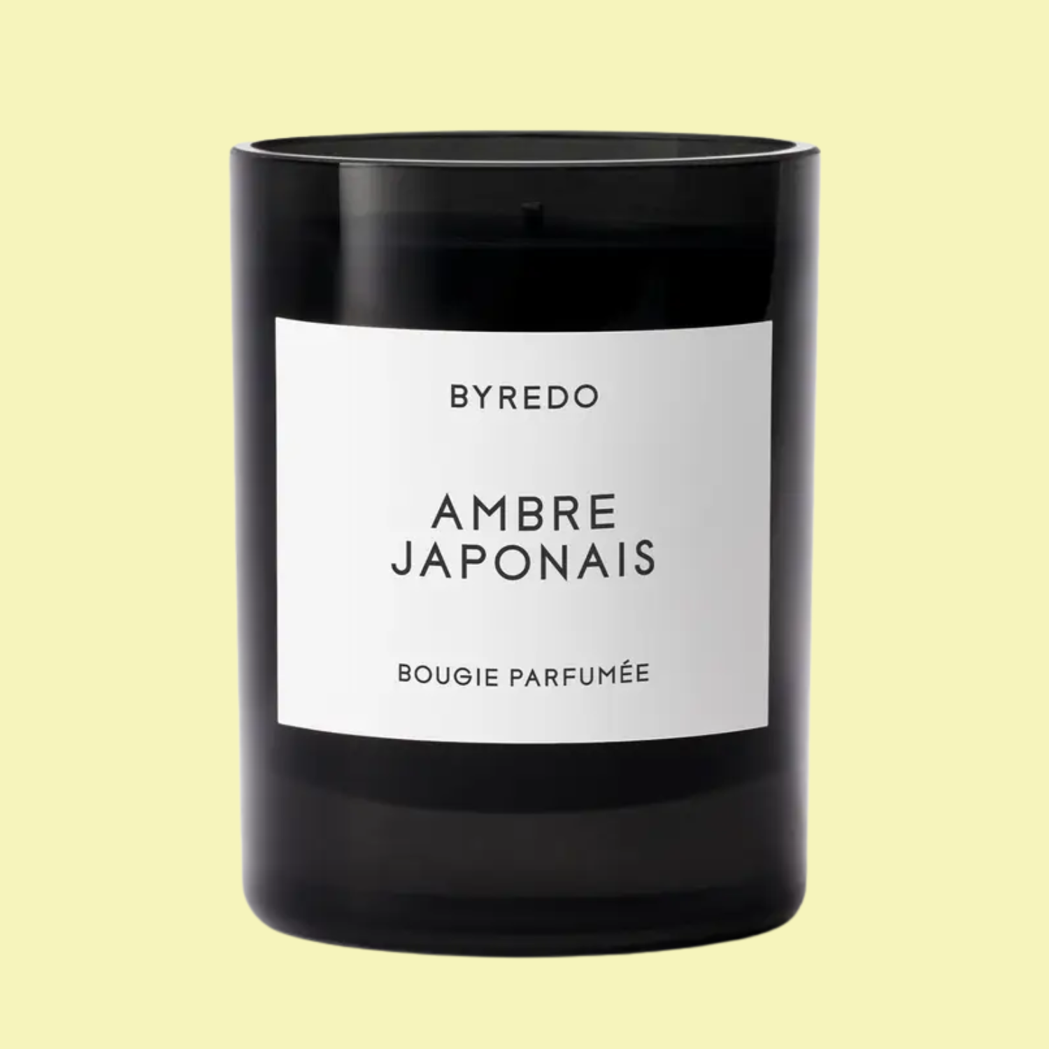 A scented candle in a black glass vessel