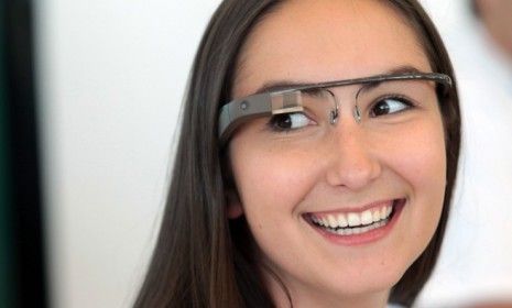 A Google employee wears a pair of Google Glass specs during the company&amp;#039;s Developers Conference on June 27: The high-tech glasses are expected to hit the market in 2014.