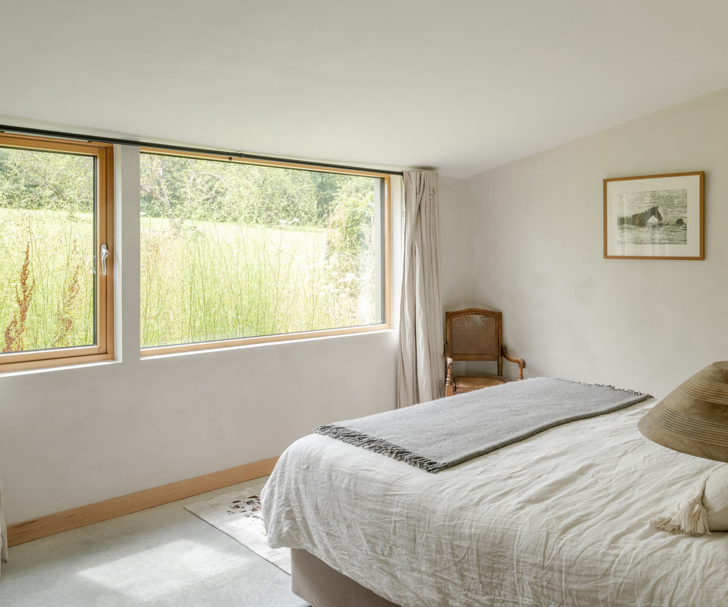 A white bedroom with a large window