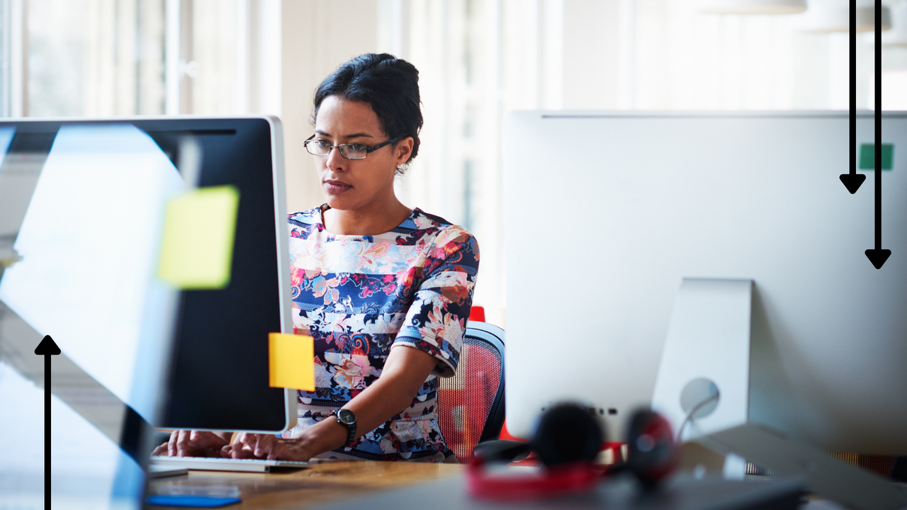 a woman working on a desk in an office space