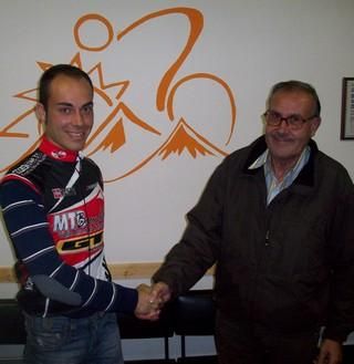 Alessandro Gambino shakes hands after signing a new contract deal.