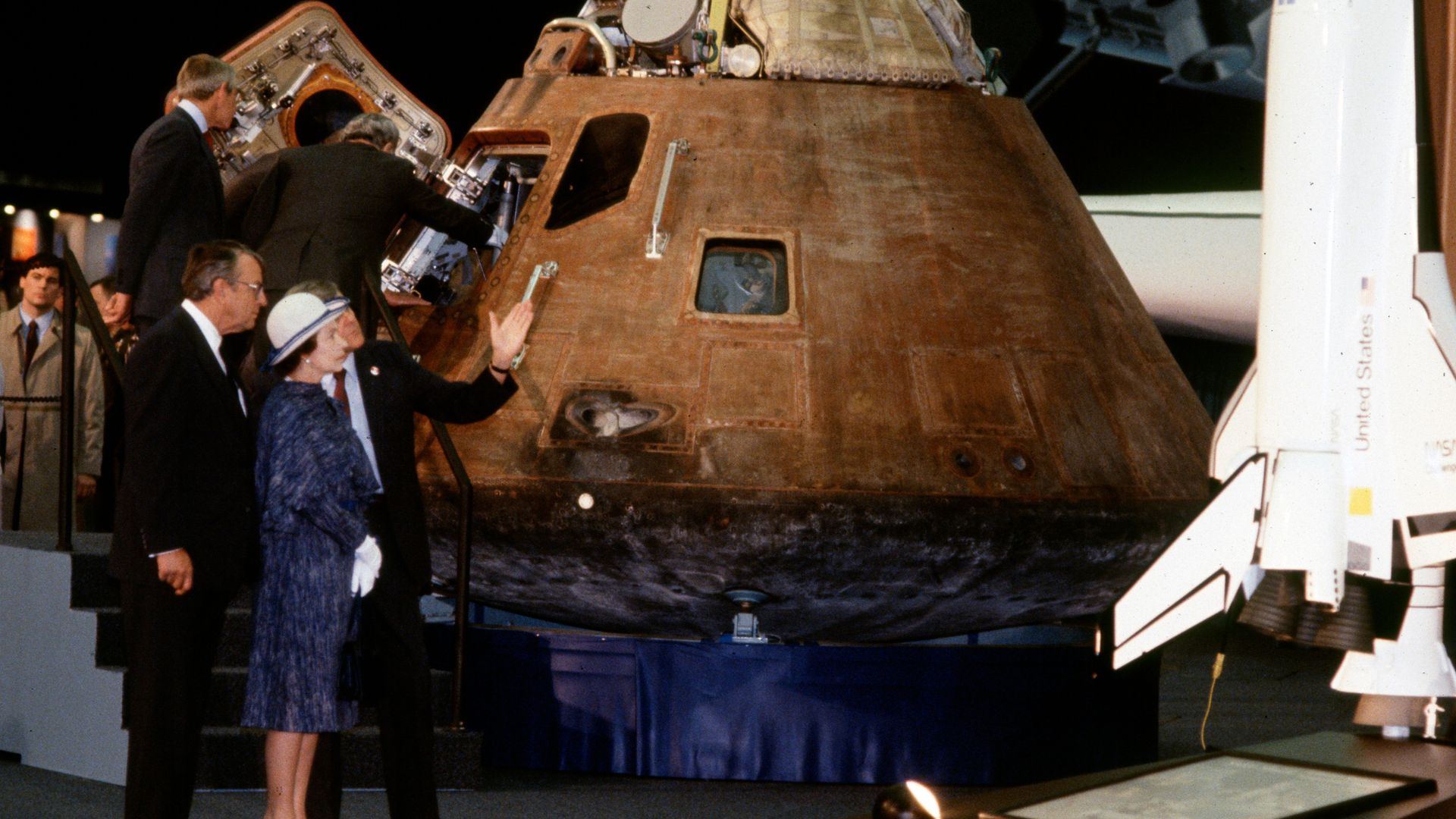 Queen Elizabeth II is shown the Apollo 14 space ship