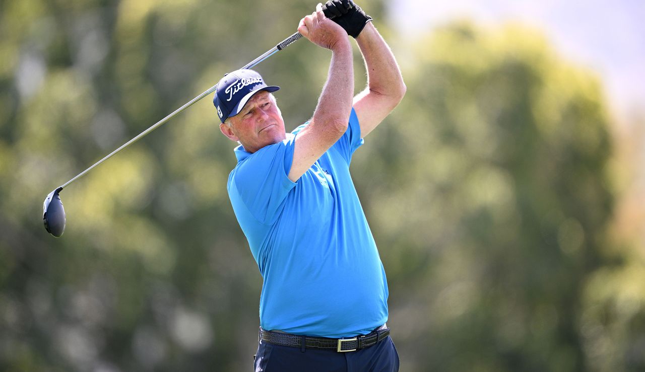 Lyle watches his tee shot as he strikes the ball with a driver