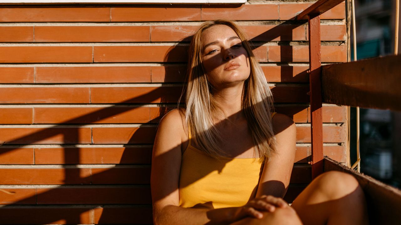 Woman sitting outside in the sun