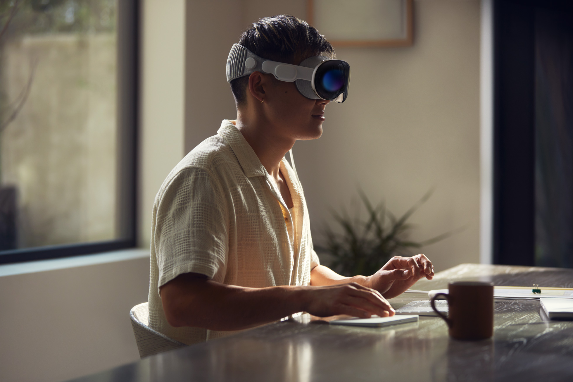 Man works while using Apple Vision Pro headset