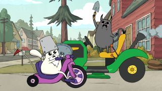 (L to R) Tom Ellis as Godcat riding a tricycle while wearing a bucket on his head and Sasheer Zamata as Devilcat riding a lawn mower and holding up a small shovel in Exploding Kittens Season 1.