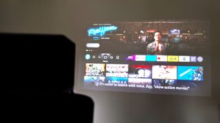 Fire TV being projected with a Fire TV Cube in the foreground.