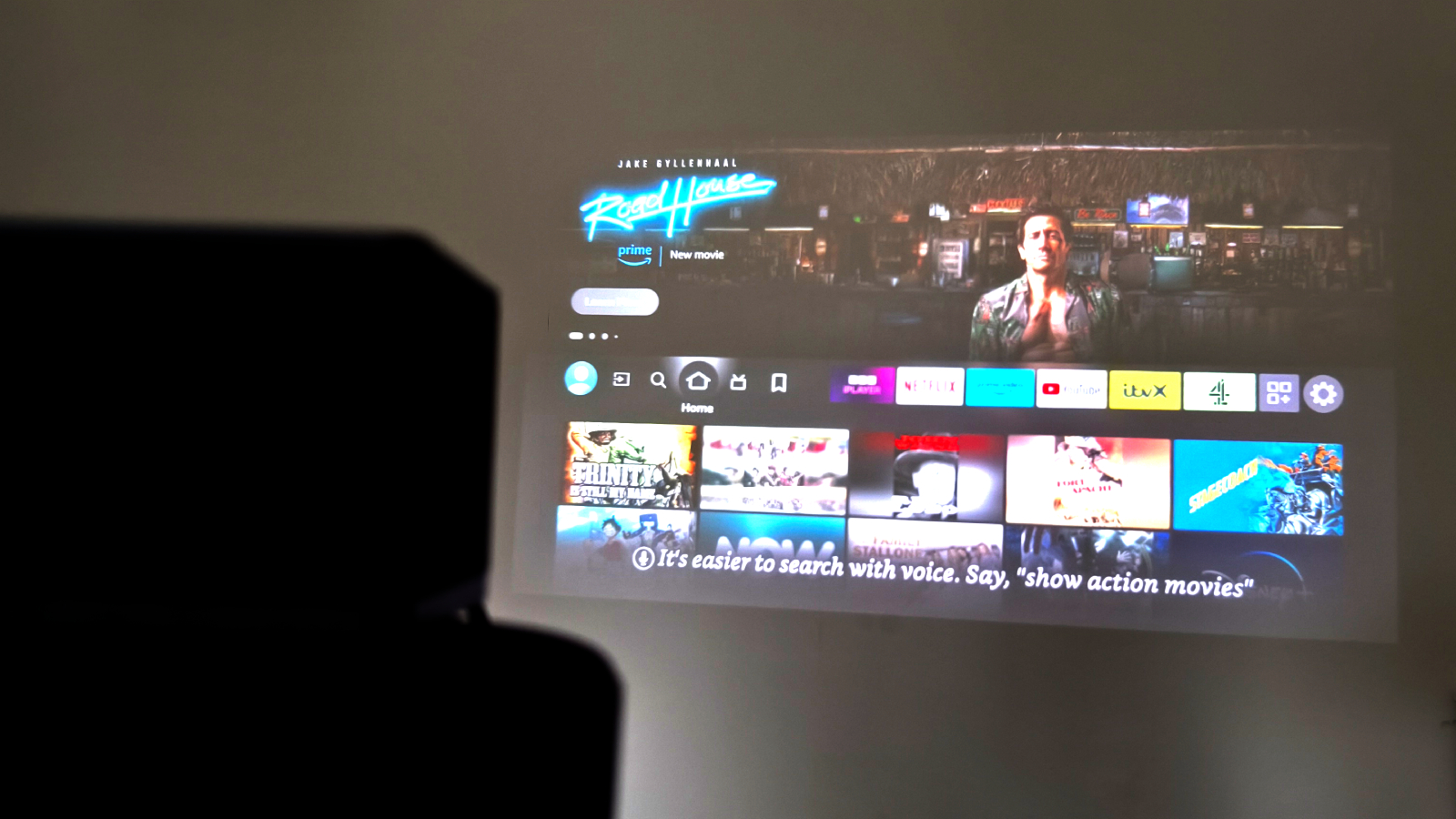 Fire TV being projected with a Fire TV Cube in the foreground.