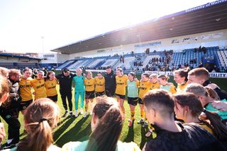 Wolves players and staff huddle on the pitch following victory in the FAWNL Northern Premier Division match between Wolverhampton Wanderers Women and Burnley Women at SEAH Stadium on March 30, 2025 in Telford, England.