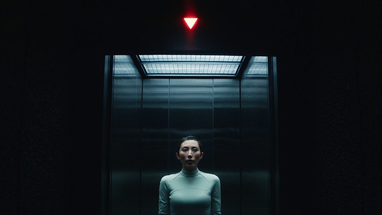 Gemma standing in an elevator that's going to go down in Severance season 2 episode 7