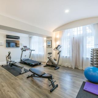 fitness room with white wall and gym exercise cycle