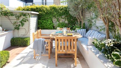 Exterior of Georgian townhouse with garden seating area and large standard anglepoise lamp