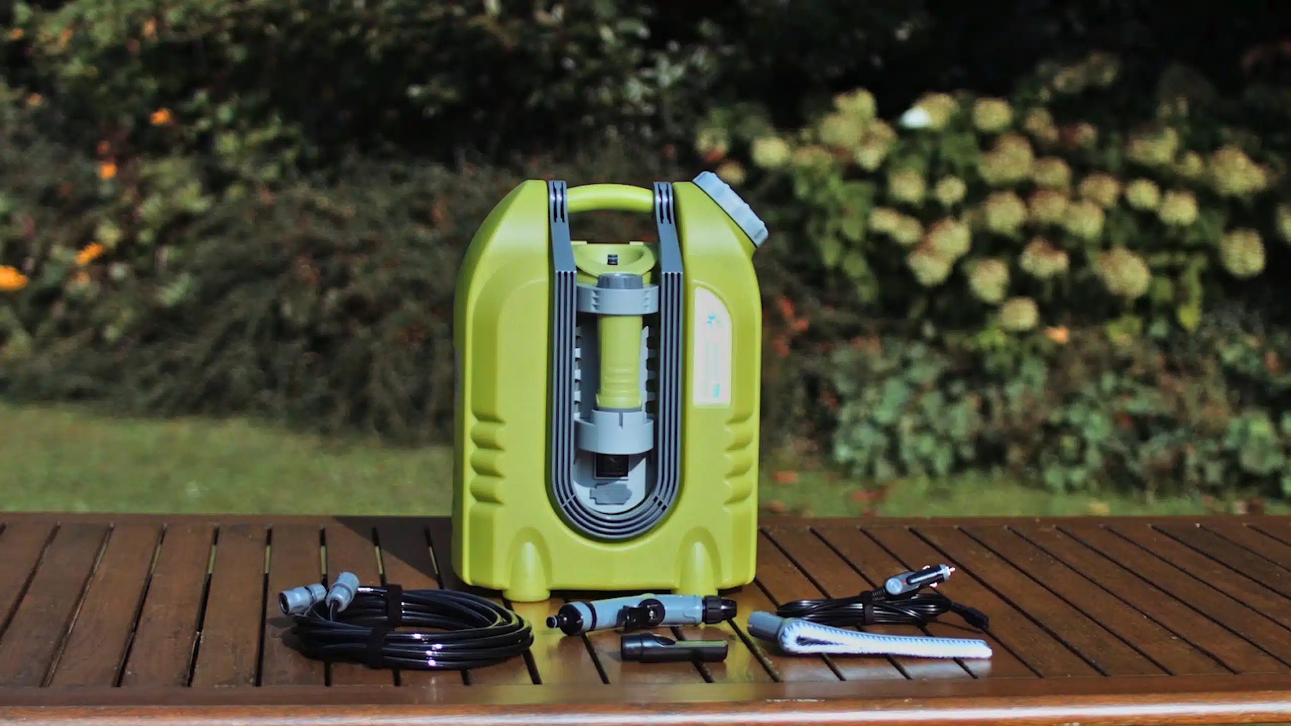 Aqua2go Pressure Washer with hose and attachments on a garden deck