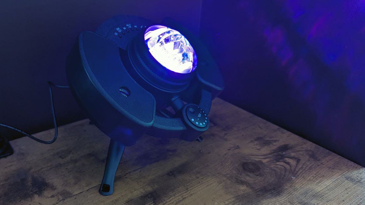 YgiTK Northern Galaxy Lights Projector during Review, on a wooden table against a dark coloured wall