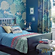 Bedroom with mystical blue wallpaper and curtains