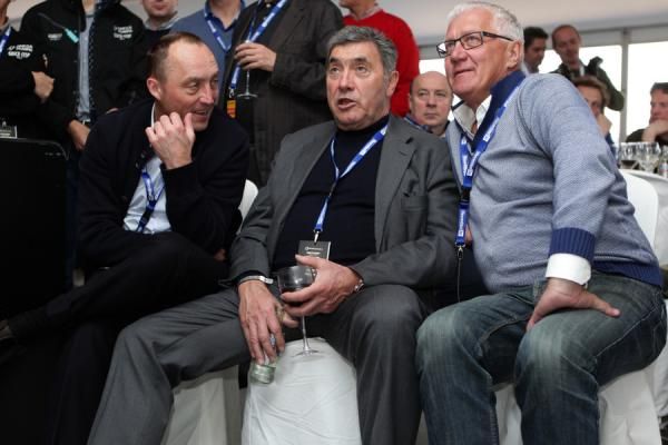 Wouter Vandenhoutte, Eddy Merckx and Patrick Lefevere watch the action on television