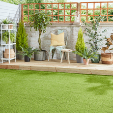 artificial grass and decking area with containers and grey fence